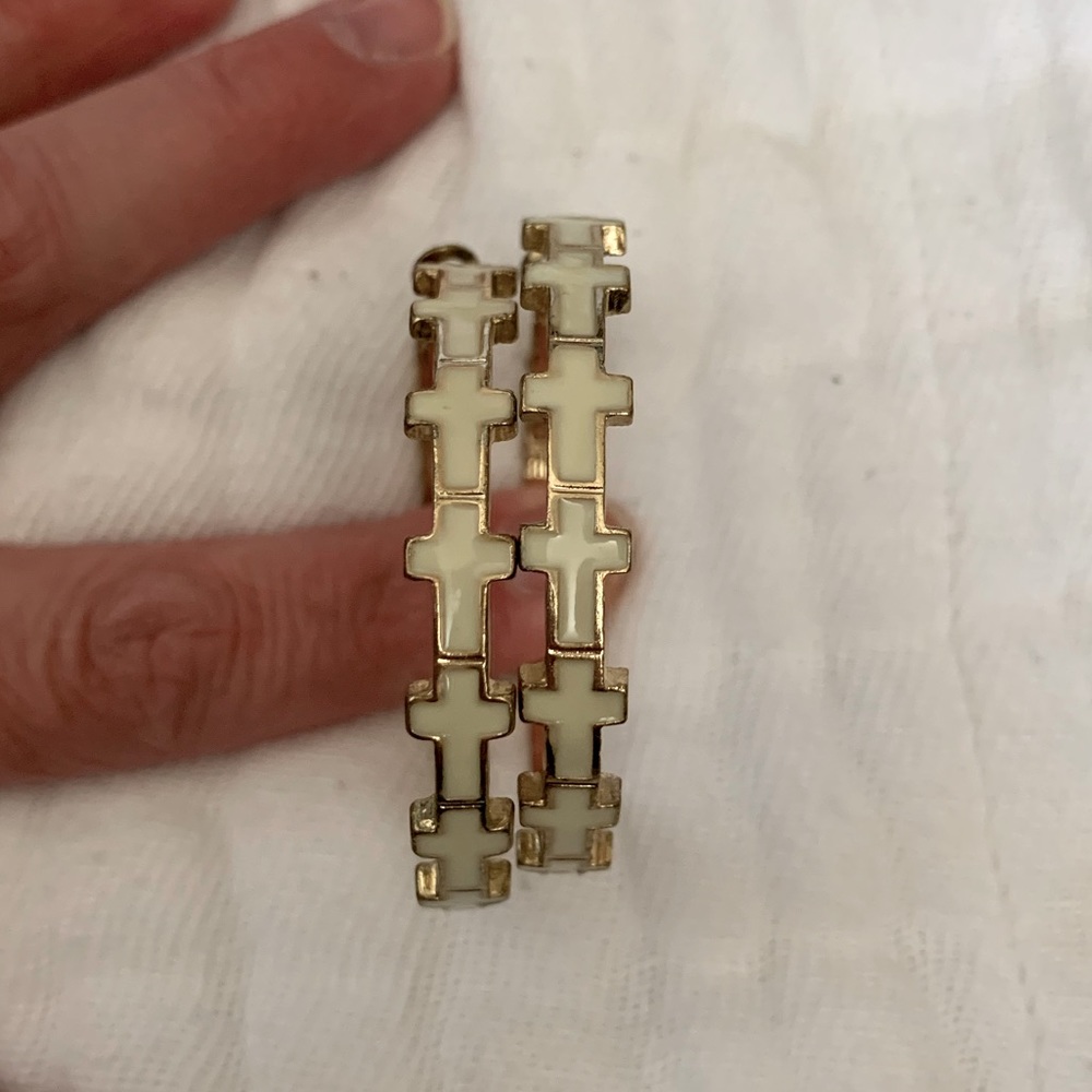 Gold tone earrings with white crosses